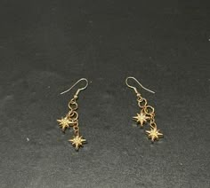 Gold Star Earrings  handmade in New England perfect for the ones who worship the moon and stars or my gold jewelry ladies. Made with stainless steel fixtures and metal charm beads. Handmade Gold Star Earrings, Gold Star Charm Metal Earrings, Dangly Gold Earrings, Star Outfit, Wardrobe Building, Earring Inspo, Gold Star Earrings, The Moon And Stars, Earrings Star