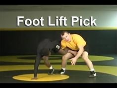 two men in yellow shirts and black shorts on a wrestling mat with the words foot lift pick