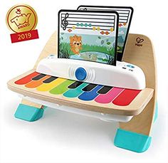 a wooden toy piano with an electronic keyboard on it's back legs and a mouse pad in the middle