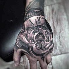 a man's hand with a clock tattoo on it