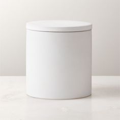 a white canister sitting on top of a table