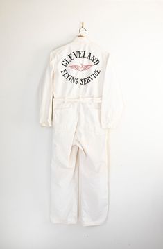 "Made in USA cotton coveralls with chainstitch embroidered detail reads \"Cleveland Flying Service\" One of a kind in amazing condition! Please message with any questions. ✂Please double bust, waist and hips to get the total measurement around the garment Approx. Size: 40 / Medium 1960s * Cotton * Unique Engineer Stripe * Perfect Condition CONDITION In excellent condition, discoloration as shown MARKED SIZE: 40 MEASUREMENTS Chest: 22\" flat (44\" doubled) Length: 65\" from collar seam down leg S Vintage Work Wear, Boilersuit Outfit, Embroidered Overalls, White Herringbone, White Jumpsuit, Mode Inspo, Fashion Line