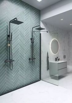 a bathroom with a shower, sink and mirror on the wall next to each other