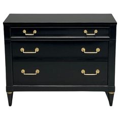 a black dresser with gold handles on it