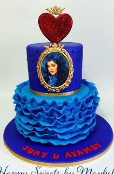 a blue cake with a picture on it and a heart above the top that says happy birthday, mary