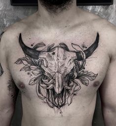 a man with a bull's skull and flowers on his chest