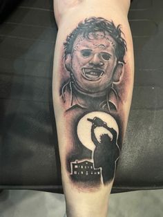 a man's leg with a tattoo on it that has an image of a person holding