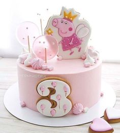 a pink birthday cake with pep the pig on top