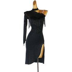 a black dress with fringes and beads on the shoulders, in front of a mannequin