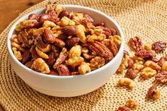 a white bowl filled with nuts on top of a table