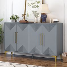 a grey cabinet with gold handles and two doors