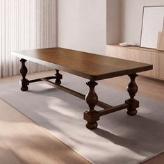 a large wooden table sitting on top of a hard wood floored floor next to a window