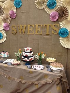 a table topped with lots of desserts and cupcakes on top of it