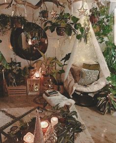 a living room filled with lots of furniture and christmas decorations on the wall next to candles