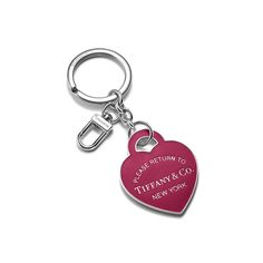 a red heart shaped keychain with the words tiffany & co in white lettering