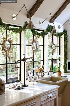 the kitchen is decorated with greenery and sunburst decorations