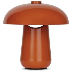 an orange table lamp on a white background