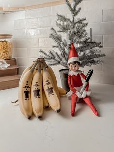 an elf is sitting next to some bananas