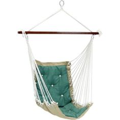 a green and white hammock chair hanging from a wooden hanger with rope