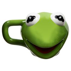 a close up of a green coffee cup with eyes on it's face and mouth