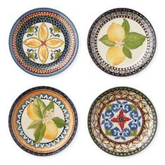 four plates with lemons and leaves painted on the sides, all in different colors