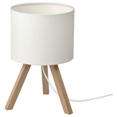 a wooden table lamp with a white shade on it's base and wood legs