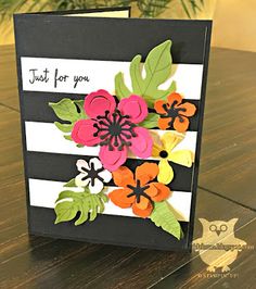 a card with flowers on it sitting on a table