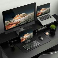 two laptops and a desktop computer on a desk