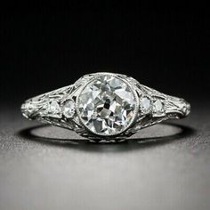 an antique style diamond ring with filigrees