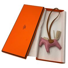 Hermès Mauve Sylvestre/Chai/Craie Grigri Horse Rodeo Bag Charm PM. This Grigri Rodeo bag charm is in Mauve Sylvestre Milo lambskin leather and accented with a Craie mane and tail and a Chai saddle and holder. Condition is brand new & comes in a box. Hermes Bag Charm, Hermes Keychain, Mauve Sylvestre, Horse Rodeo, Girl Essentials, Mane N Tail, Twilly, Gianni Versace, Hermes Bag