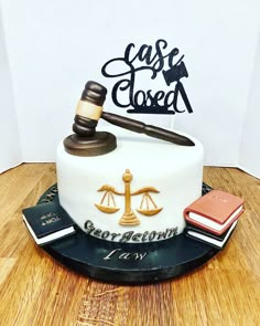 a cake with a judge's gaven and books on it