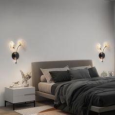 a large bed sitting next to two lamps on the wall