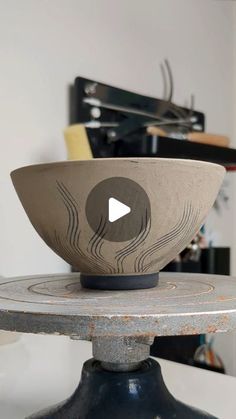 a bowl sitting on top of a metal stand