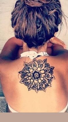 a woman with a tattoo on her back