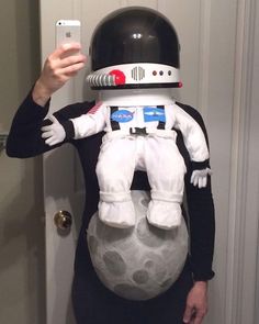 a person in an astronaut costume taking a selfie