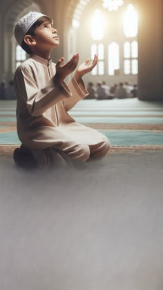 a young boy sitting on the floor praying