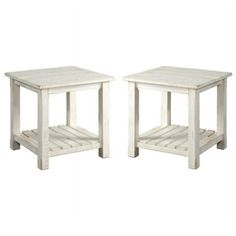 a pair of white side tables sitting next to each other