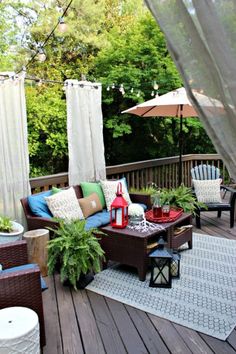 a deck with chairs, tables and umbrellas on it