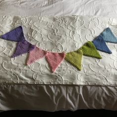 there is a crocheted bunting on the bed