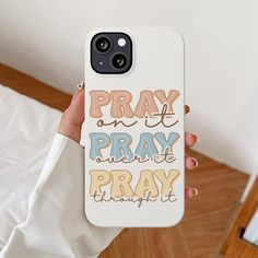 a person holding up a phone case with the words pray and pray in different colors