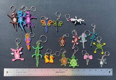 a group of different colored key chains sitting on top of a measuring ruler next to each other