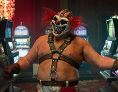 a man dressed as a clown in front of slot machines