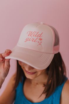 These trucker hats are our new favorites, and they will be yours too! Each style of hat has an adjustable band. Wear them with your hair down or up, and it will instantly make any outfit complete. This hat is pink with, "Wild Girl" printed in darker pink, colored text. Pink 5-panel Trucker Hat For Spring, Cute Snapback Baseball Cap For Summer, Adjustable Trucker Hat For Spring, Pink Baseball Cap For Beach With Curved Bill, Cute Pink Baseball Cap For Summer, Cute Summer Hats With Curved Bill, Pink Curved Bill Hats For Summer, Adjustable Trucker Style Mini Cap, Adjustable Trucker Mini Cap