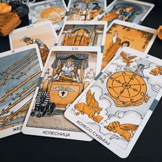 several tarot cards with pictures of people and animals on them sitting next to each other