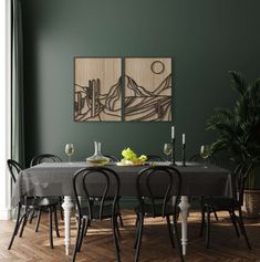 a dining room with green walls and wooden flooring, two paintings on the wall