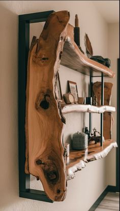 a wooden shelf that has various items on it and is mounted to the wall in front of a mirror