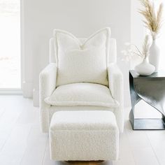 a white chair and ottoman in a room