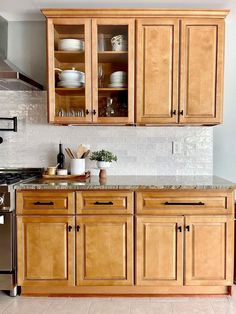 a kitchen with wooden cabinets and stainless steel appliances