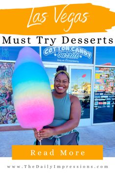 a woman holding an ice cream lollipop in front of a building with the words las