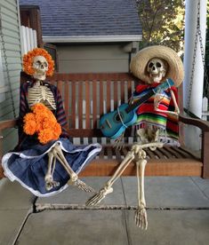 two skeletons sitting on a porch swing with guitars and flowers in their hair, wearing sombreros